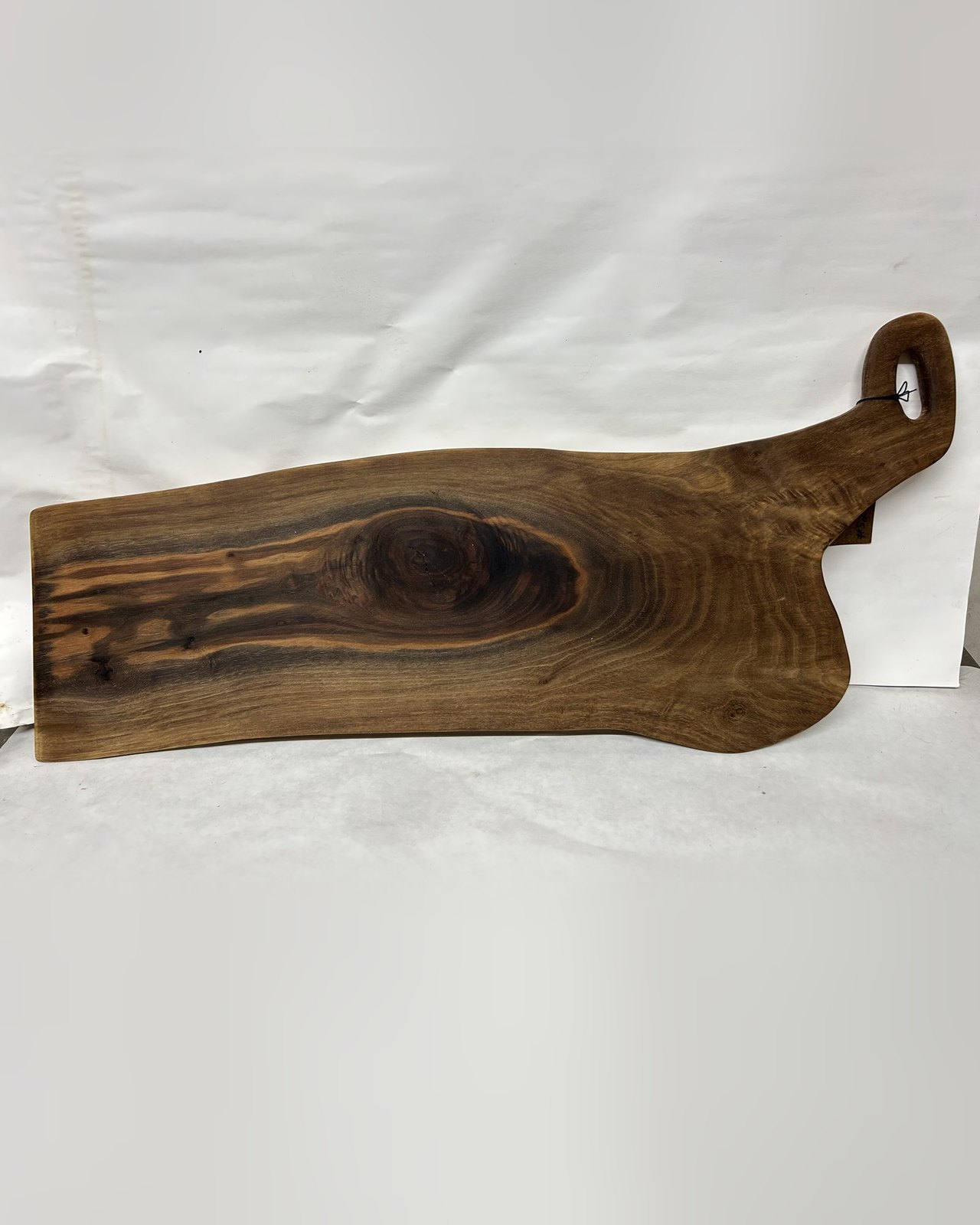 Live edge walnut serving board with a shark tail handle